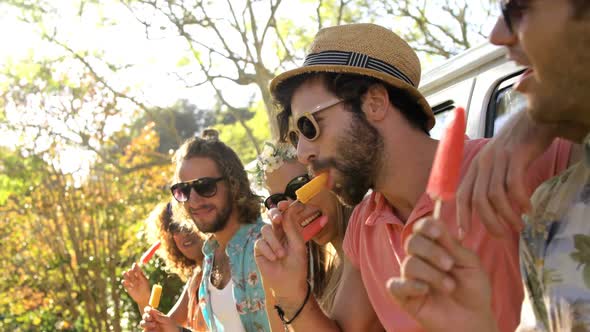 Group of hipster friends enjoying and eating ice cream