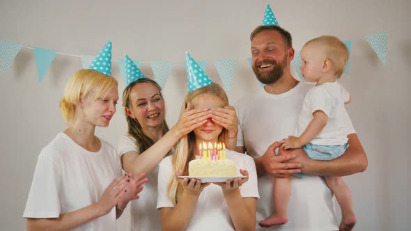 Caucasian Girl Birthday Girl Blows Candles on the Cake Making a Wish Celebrating a Birthday with Her