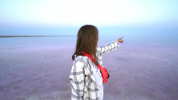 Happy Joyful Woman Enjoying Nature Landscape at Pink Salt Lake at Evening