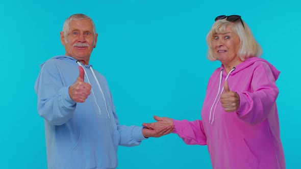 Grandmother Grandfather Showing Thumbs Up Pointing Empty Place Advertising Area for Commercial Text