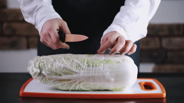 A Cauliflower in a Cling Film Is on the Board