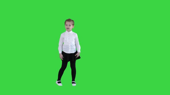 Cute Little Girl Smiling and Confidently Talking To Camera on a Green Screen, Chroma Key