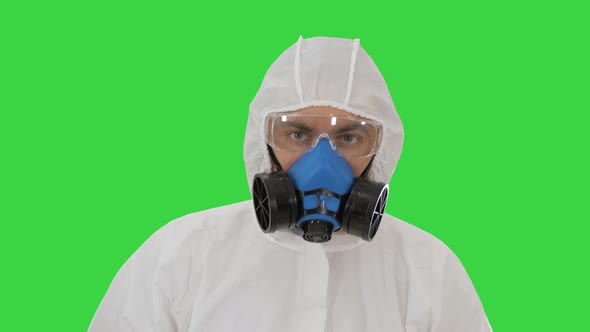 Download 26522847-Person Wearing a Hazmat Suit and Mask Walking on ...