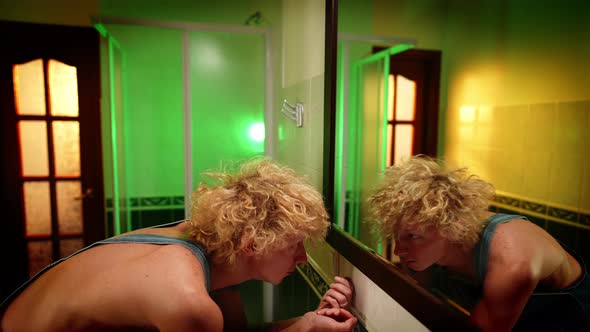 Desperate Frustrated Caucasian Queer Man Standing Up Looking at Reflection in Mirror