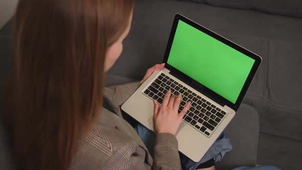 Businesswoman Working on Laptop Green Screen Chromakey on Sofa at Home
