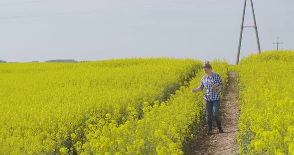 Farmer Examining Oil Seed Canola Field