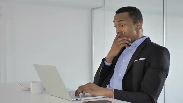 Shocked Casual AfroAmerican Businessman Working on Laptop Astonished