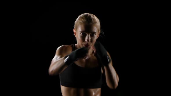 Shadow-boxing Blonde Girl. Slow Motion in the Studio