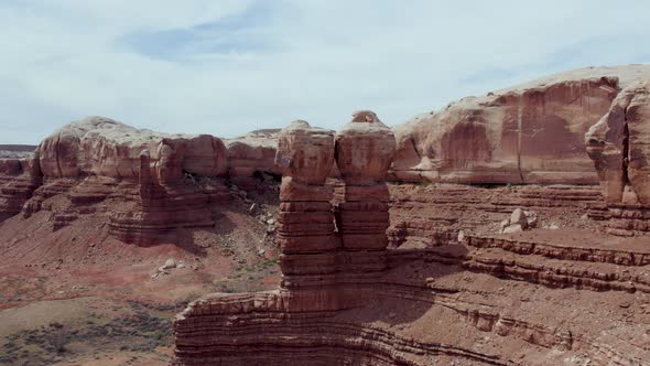 Prominent Navajo Twins Eroded Rock Formation Towering Over Bluff Town In Utah, USA. Aerial Shot