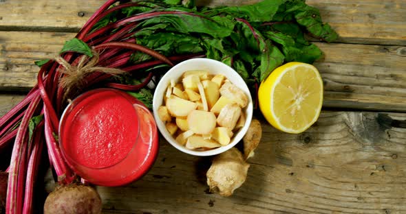 Various ingredients with juice on wooden table 4k