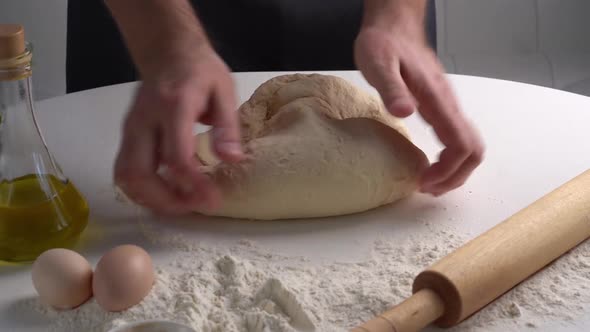 Male Hands Kneading Dough for Braed or Pastry