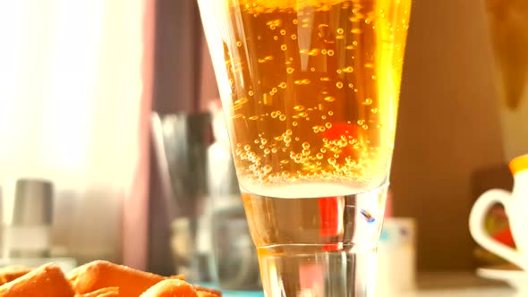 Close-up of a beer glass with bubbles rising up, 4K video