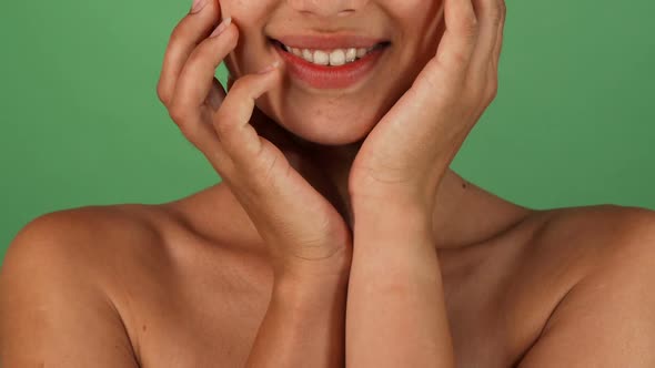 Stunning Happy Woman Smiling and Cupping Her Face with Her Hands