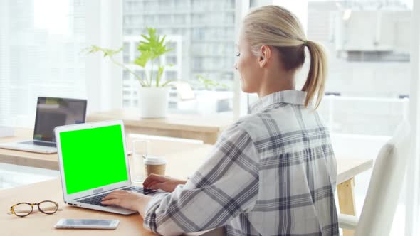 Businesswoman working over laptop at her desk