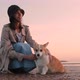 Woman Strokes Dog and Sits on Sea Beach During Evening Sunset Outdoors Spbi - VideoHive Item for Sale