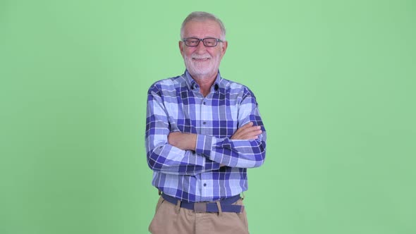 Happy Senior Bearded Hipster Man Smiling with Arms Crossed