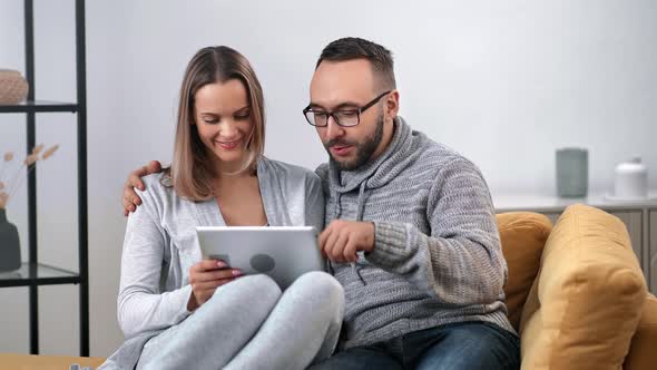 Happy Couple Surfing Internet Use Tablet Pc Relaxing on Couch