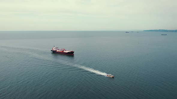 Drone Shot of a Small Ship and a Tanker with Liquid Bulk Cargo in Transit on Black Sea Batumi