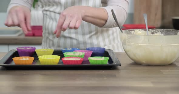 Womans Hands with Cookie Cutters with Muffin Dough