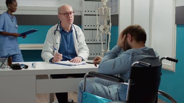 Health Specialist Doing Consultation with Wheelchair User