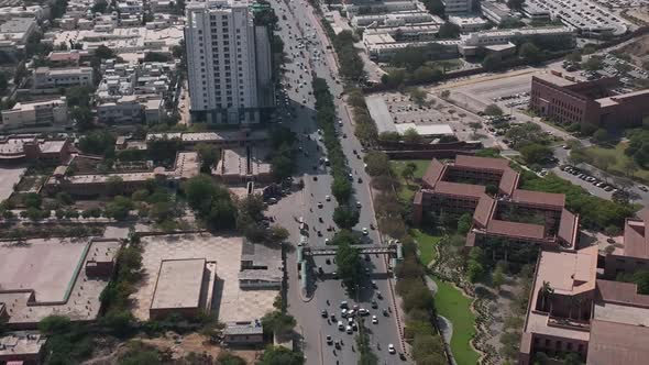 Aerial Flying Over Highway Beside Agha Khan Hospital In Karachi. Dolly Back, Zoom Out