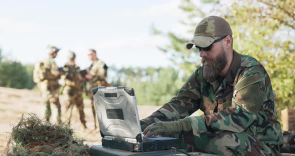 Group of Soldiers Waiting to Go Into Action in Field Dressed Prepared with Equipment and Weapons