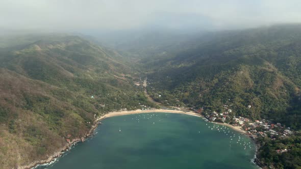 Panoramic View Of Resort Town And Lush Rainforest Under Misty Sky In Yelapa, Jalisco, Mexico. Aerial