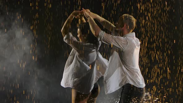 Man and Woman Wet From the Rain, Dance a Passionate and Graceful Salsa Dance. Raindrops Glisten on a