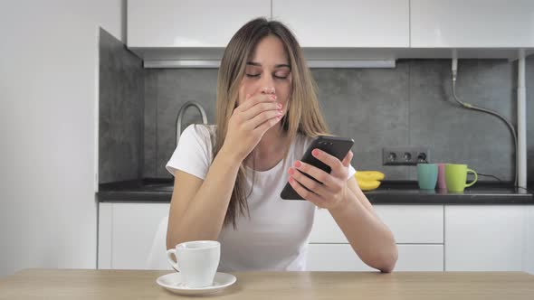 Relaxed Young Woman Using Smart Phone Surfing Social Media, Checking News, or Texting Messages