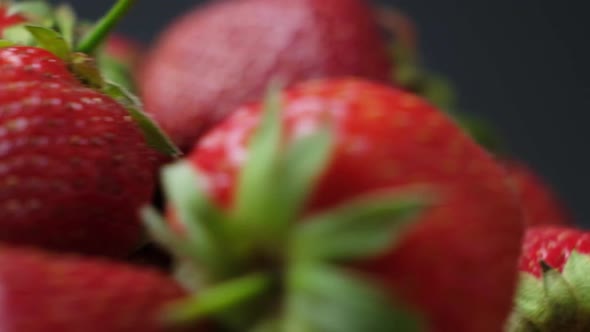 Macro Video of Whirling Strawberries on a Black Background