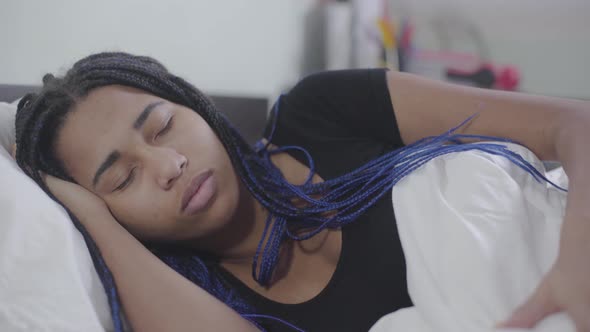 Close-up Face of African American Girl Sleeping and Fixing White Blanket, Teenager with Dreadlocks