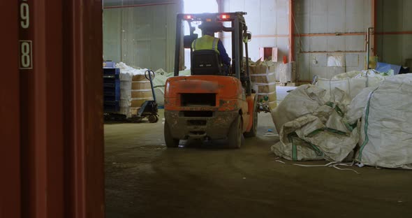 Male worker operating forklift in warehouse 4k