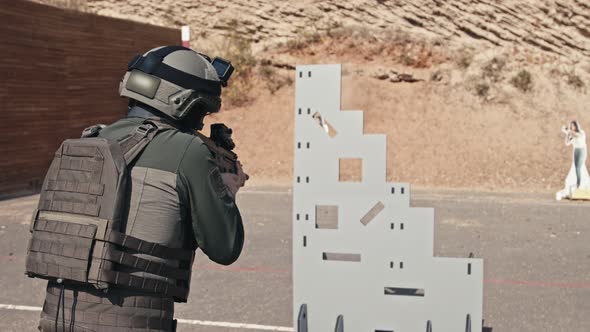 Slow motion of soldier shooting automatic rifle in a range alt