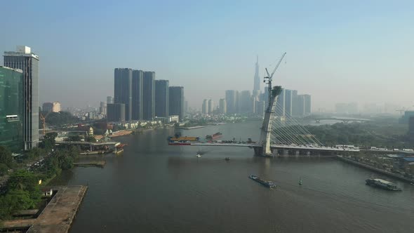 Drone view of Saigon River, Ho Chi Minh City and new Thu Thiem Bridge under construction on a sunny