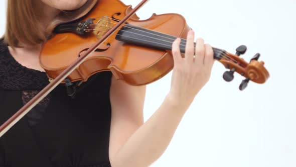 Redhead Woman Playing the Violin on a White Background. Close Up