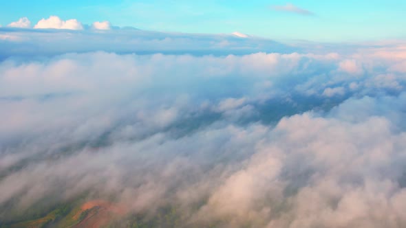 4K Drone Flying through the clouds at dusk or dawn. Aerial top cloudscape