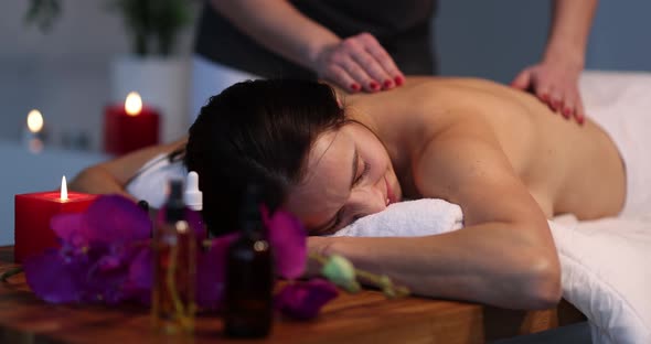 Young Woman Enjoying Body Massage at Spa