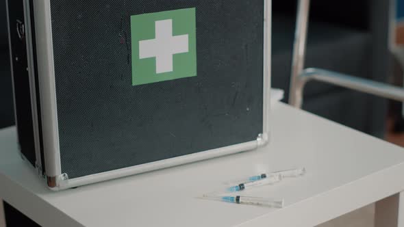 Close Up of Medical Suitcase and Syringes for Healthcare on Table