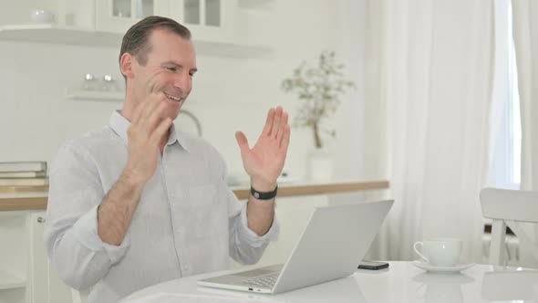 Middle Aged Man Doing Video Call on Laptop at Home 