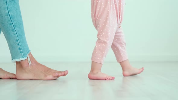 Feet of Walking Mom and Baby