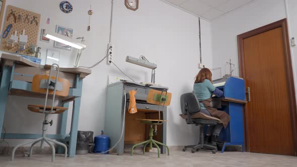 Portrait Of A Working Artisan Jeweler In Her Studio