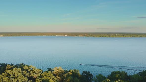 Aerial Shot of a Speed Boat on Blue Lake in the Summer