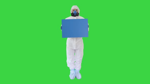 Lab Scientist in Safety Suit Holding Board on a Green Screen, Chroma Key