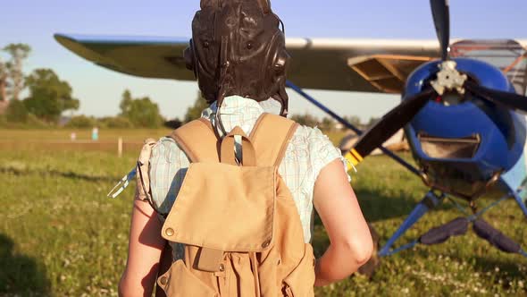 Woman Pilot Portrait Walking To Her Small Airplane at Summer Sunny Weather