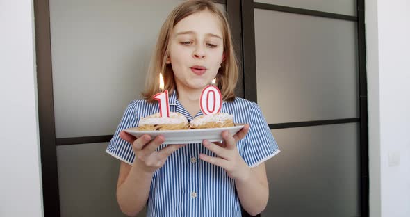 A Birthday Party for a Happy Cute 10 Year Old Girl and Blowing Candles on a Cake