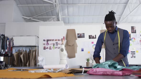 Mixed race man working in fashion office