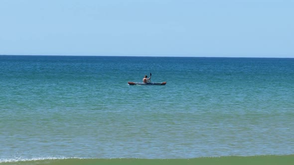 Man Kayaking at Sea, Sunny Day. Tracking Shot.