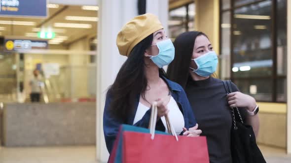 Asian woman standing outdoor wearing protective mask, covid-19 world pandemic,