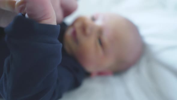 Mom Dressing Up Her Newborn Baby , Close Up