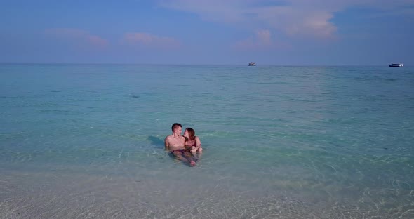 Fun couple married on vacation have fun on beach on summer white sandy background